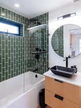 The bathroom, positioned on the first level, includes a small vanity, sink, and toilet by Moen.