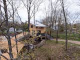 All raw materials are sourced locally to reduce the overall carbon footprint - as well as eliminate additional costs on the client. This includes the wood chips - which were initially a waste product but repurposed as ground coverage for this CABN show home. The chips are also FSC certified. The home itself sits on  Photo 9 of 9 in This $299K Prefab Cabin Could Be Coming to the Woods Near You