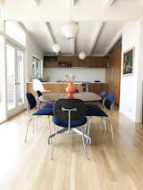 Dining Room, Ceiling Lighting, Light Hardwood Floor, Gas Burning Fireplace, Chair, and Table Open Kitchen and Dining Room  Photo 5 of 9 in The Oscar House by Todd Bachenheimer