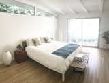 Bedroom, Light Hardwood Floor, Night Stands, Bench, Bed, and Floor Lighting Master Bedroom  Photo 7 of 9 in The Oscar House by Todd Bachenheimer