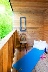 A second balcony at the rear of the house provides a complimentary counterbalance for the residents. The outdoor space connects off the master bedroom and serves as a quiet retreat amongst the trees. Wood is used to provide a natural respite and the perfect yoga retreat.