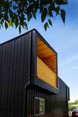 Exterior, House Building Type, Metal Siding Material, Flat RoofLine, and Metal Roof Material Cedar planks bring a warm liner to the industrial metal cladding.  Photo 5 of 17 in #ONE368_Scott by Jay Lim
