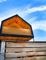 Cedar fence boards are used as an economical finish for the house's balconies.