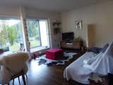Charming living-room with bright sun-room and yard.