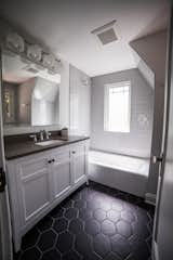 Bath Room, Engineered Quartz Counter, Wall Lighting, Alcove Tub, Undermount Sink, Ceramic Tile Floor, and Subway Tile Wall Guest Bathroom  Photo 17 of 27 in Upper Terrace by Mackenzie Reynolds