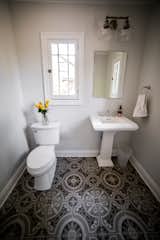 Bath Room, Pedestal Sink, Two Piece Toilet, Wall Lighting, and Porcelain Tile Floor Main Floor Powder Room  Photo 18 of 27 in Upper Terrace by Mackenzie Reynolds