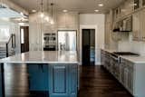 Wall Oven, Wood Cabinet, Wine Cooler, Subway Tile Backsplashe, Pendant Lighting, Cooktops, Microwave, and Dishwasher Kitchen  Photo 20 of 58 in Hole in One by Mackenzie Reynolds
