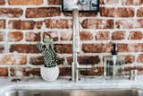 Kitchen, Wood Cabinet, White Cabinet, Brick Backsplashe, Terrazzo Floor, Marble Counter, and Undermount Sink Kitchen Faucet  Photo 20 of 31 in Frindle by Mackenzie Reynolds