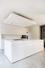 The sleek white-and-concrete interior fit-out provides a contemporary, open-plan living space for the young family.