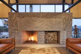 The 16-foot fireplace is crafted from local granite and features a five-ton, live-edge mantle stone that carries the marks of its making.