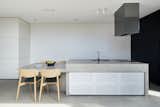 The architect integrated a dining table into the kitchen island, embracing the common Australian practice of gathering informally in the kitchen.