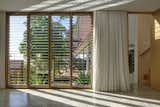 The multipurpose room looks over the garden. The outdoor shower visible in the garden is screened by a timber fence, the only area of fencing to the public. 