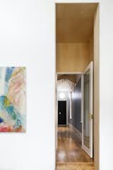 A plywood vestibule serves as a transition space between the private areas (including the bedrooms) and the public living areas.
