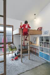 The boys’ bedrooms have loft beds that create play spaces below. As a result, their toys are stored and used in their bedrooms instead of shared living spaces.
