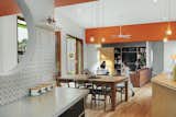 Kitchen and dining area at The FUN House by Nine Muses Architecture & Design.