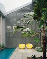 The outdoor spaces—including a courtyard with a small pool—were formed by simply removing the original roof toward the end of the construction, allowing dry working conditions for the majority of the construction period.