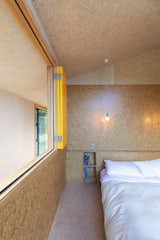 Small storage nooks are built into the walls beside the beds, avoiding the need for bedside tables.