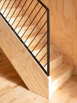 Architect Catherine Milanese wanted to use a single material—fir plywood—for the stringer, the stairs, and the risers, visually integrating the stairway with the wood box that contains the mezzanine level.