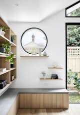 In Fitzroy North, an inner-city suburb of Melbourne, Australia, Atlas Architects reimagined a heritage Victorian terrace house as a sanctuary for a librarian and her cat, Dot.  A timber shelf below a porthole window in the living space offers a lookout for the owner’s pet. "The circular window awning adds an irregularity to the contemporary interpretation of the heritage place, creating a point of interest," says architect Aaron Neighbour. "Most importantly, it provides a porthole out to the world for the ‘queen of the castle’—the cat."
