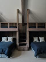 The timber-framed bunk beds are built into the soaring space.