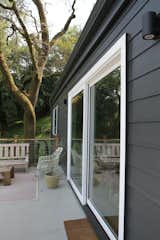 A large, sliding-glass door replaced the French doors, allowing the living space to connect to the outdoor dining area and for the living area be expanded outside in warmer months. An aged timber awning was also removed, creating a sleeker, more contemporary facade.