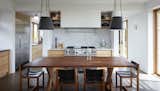 The dining table and chairs in the kitchen were handcrafted by the homeowner from timber harvested on-site.