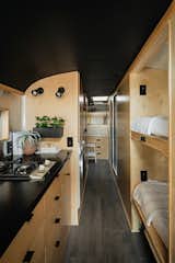 Kitchen and bunks of Scandinavian Skoolie by Killdisco Design.