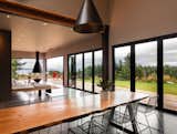 The communal dining table in the main house was custom-made by a local woodworker and island timber mill owner, Joe Romano, in collaboration with WindowCraft. Raw metal supports for the table were fabricated by Salish Metalworks on Orcas Island, a sister island to San Juan. 
