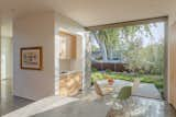 Pocketed sliding doors connect the breakfast nook to the front yard, which is screened from passersby with olive trees. “Enjoying the early morning light that enters the breakfast nook is a great way to wake up while having a cup of coffee,” says Joseph. 