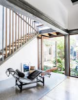 The design intention was to keep the stair as simple and understated as possible. It's crafted from plate steel stringers and blackbutt timber treads. A central steel truss "hovers" between the stair flights and includes blackbutt uprights. A pivoting door beneath the stair opens out to the courtyard.