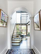 The archway at the end of the entrance hall was opened up to reflect the original floor plan of the terrace, and now leads directly to the stairs and the living/dining area. 