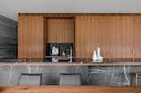 The kitchen counters are Pietra Gray marble, which complements the refinement of the spotted gum timber joinery.