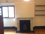 Before: The guest bedroom before the renovation. As in other rooms in the front wing, the original fireplace has been restored.  Photo 23 of 37 in Before & After: A Blighted Boarding House in Sydney Is Now an Adaptable Courtyard Home