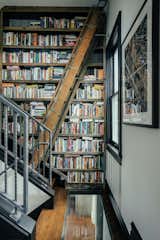 Metalworker Rick Gage made the library’s custom bookcase on the remnants of the home’s original, Depression-era second staircase which dates back to when the home was a duplex. A pullout ladder provides access to the books.