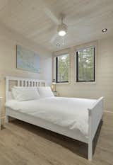 Bedroom of Kahshe Lake Cottage by Solares Architecture.