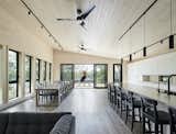 Dining room and kitchen of Kahshe Lake Cottage by Solares Architecture.