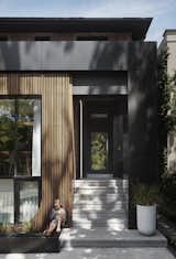 "One of the clients’ families has a history of being heavily involved in beautiful vintage wooden boats," says Wallace. "The timber screen plays off that idea and introduces a very warm, natural material to face the street." The timber screen wraps around the side window to offer added privacy from the main entrance.&nbsp;