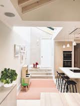 The space beneath the skylight is used as a play area by the couple’s young daughter. A soft pink rug helps to define this as a distinct zone in the open-plan space. It will eventually be transformed into a study area for the couple’s daughter. "I've designed a run of joinery that will go along that wall which will have a fold down desk for homework and more storage," says Julia.&nbsp;