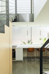 The kitchen countertop extends the length of the space becoming the dinning surface, negating the need for a dining table in such a small living space.&nbsp;
