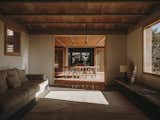 The kitchen and living area leads to a traditional porch that connects to the second volume, which contains the private spaces. “We have broken up the distinction between interior and exterior spaces by using a central porch, which functions as a living area and opens up the entire home to the surroundings,” says architect Benjamin Iborra Wicksteed.