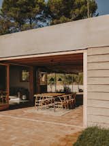 For cross ventilation, the residents can open and close the large sliding doors around the porch, which the architect describes as “the heart of the home.” Likewise, windows are positioned to provide breezes when necessary. 