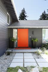 The exterior of the front door has been painted bright orange, a reference to the shipping containers' (painted over) Cor-Ten steel. From the street, this is the only indication of what lies inside.