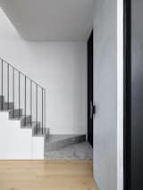 The stair is crafted from Ceppo Di Gre stone that was supplied and installed by Granite Marble Works. “There is just one quarry that mines it, and it has the most beautiful sedimentary quality with big dramatic flecks of white and black amongst its pebbly composition,” says architect Bronwyn Litera.
