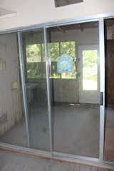 Before the renovation, the hallway/gallery that runs through the bungalow led to a porch. “At some point a screen porch had been tacked on to the back of the house,” says architect Miguel Rivera. “It was poorly built—and on top of that, it was infested with spiders and who knows what else.”