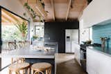 From the central kitchen island, there is a continuous line of sight to the garden. “Milli loves her indoor plants,” says builder Hamish White. “The tree views from most windows, and all the indoor plants makes you feel as if nature is never far away.” 
