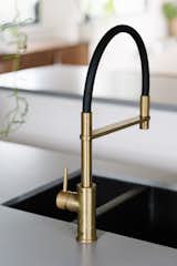 The kitchen tap is a Pegasi M pulldown sink mixer from Faucet Strommen.&nbsp; The brass detail brings a sense of warmth to the kitchen island.