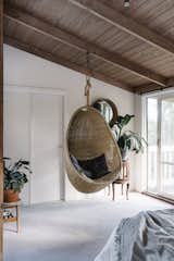 The master bedroom has a hanging egg chair identical to the one on the deck.&nbsp;