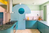 The curved blue kitchen larder has a projecting “nose” that illuminates the worktop and a mirrored eye that “winks” each time the door is opened. 