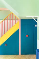 "Life is too short for beige," was the guiding motto for homeowners Tamsen Chislett and Max Lines, who tasked Office S&amp;M cofounder Catrina Stewart with renovating their Victorian terrace in London. "The name of the project, MO-TEL, is linked to this sense of escapism," says the architect, who added blue-painted doors and bright-red knobs to a bold pantry setup beneath the pink-and-yellow banister. Bonus: The clients’ son also loves to play hide-and-seek in the vibrant cupboard.&nbsp;&nbsp;