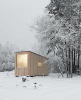 Delo Design cofounders Arsenii Brodach and Anastasia Gulyaeva constructed this compact, modular cabin in a pine forest near St. Petersburg, Russia, for a&nbsp;couple with a young child who spend their weekends here while a larger country home is under construction.